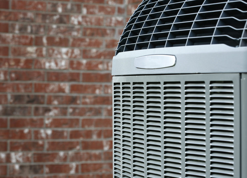 Close up shot of High efficiency modern AC-heater unit on brick wall background
