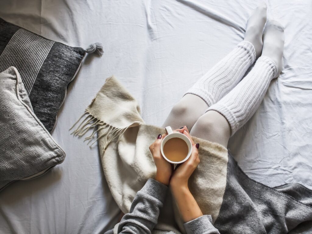 cozy mug on bed